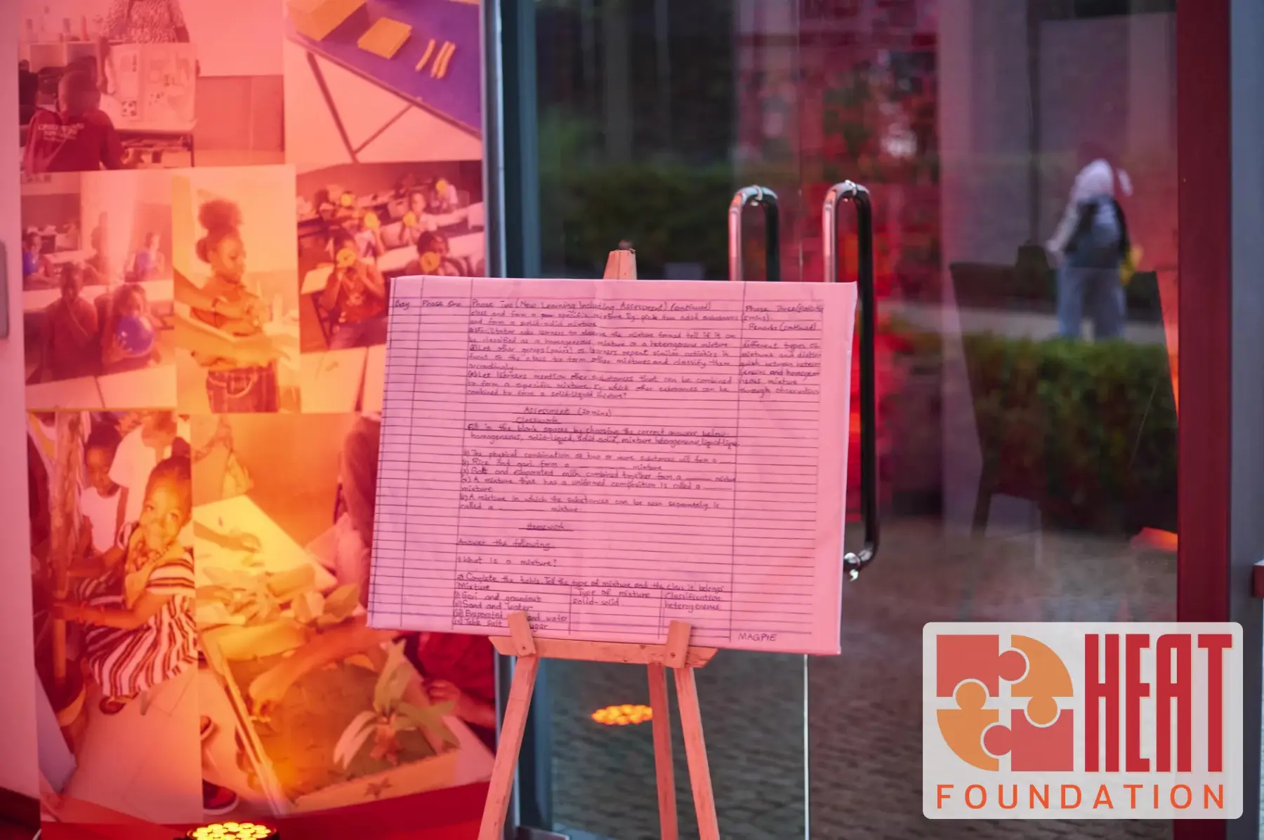 Teacher lesson plan displayed at the HEAT showcase beside classroom photographs