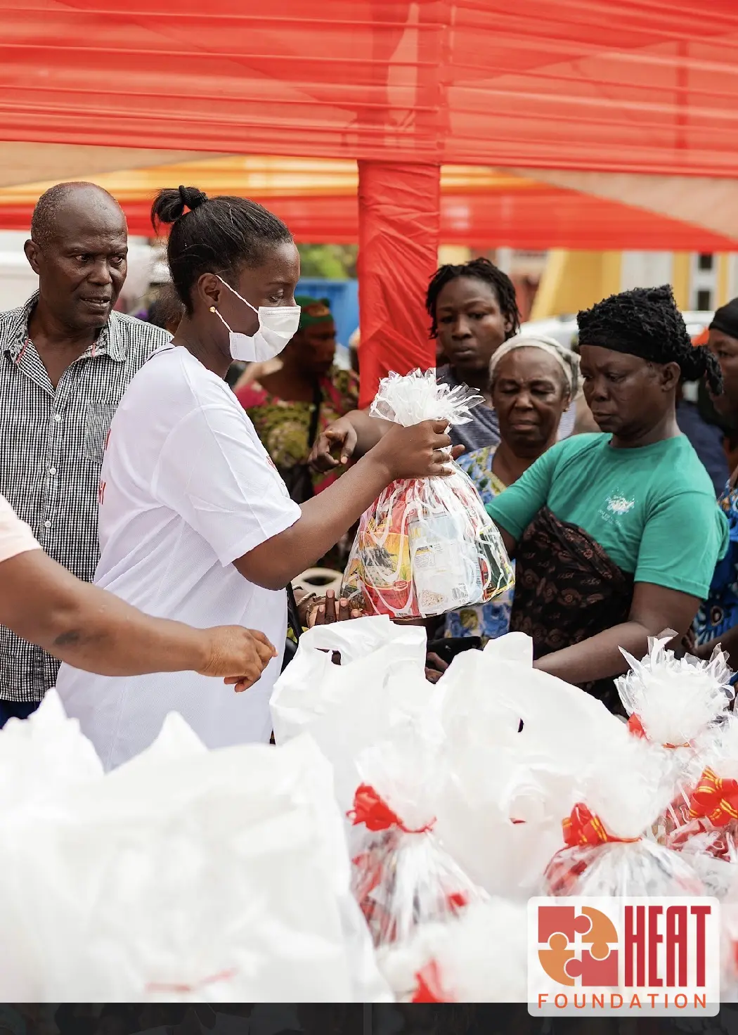 A food hamper being handed to a family at the Christmas drive