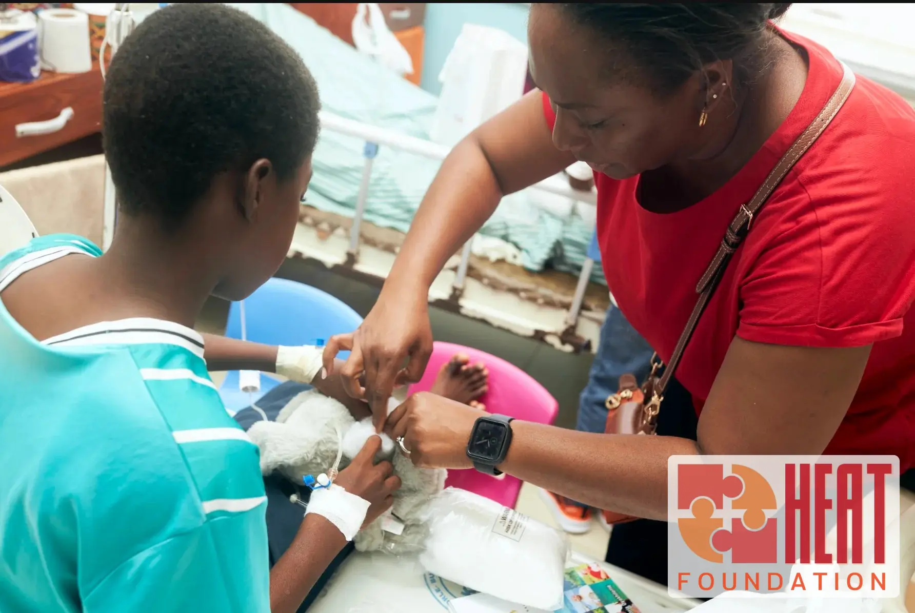 Child and team member making a hospital buddy bunny on the ward
